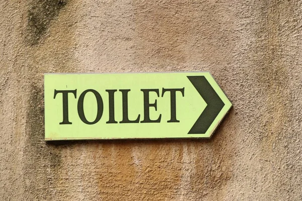 Toilet sign on wall — Stock Photo, Image