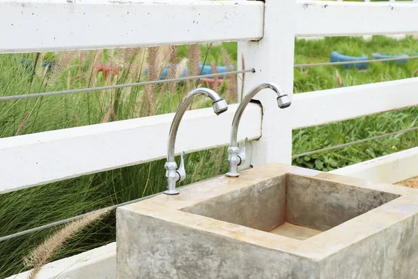 Faucetc and cement sinks — Stock Photo, Image