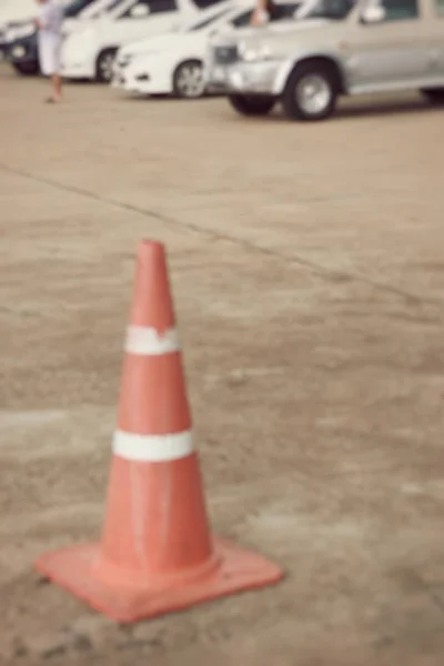 Blurred traffic cone and car — Stock Photo, Image