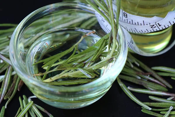 Rosemary herbs with oil — Stock Photo, Image