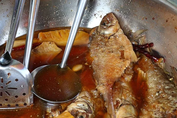 Boiled fish sauce at market