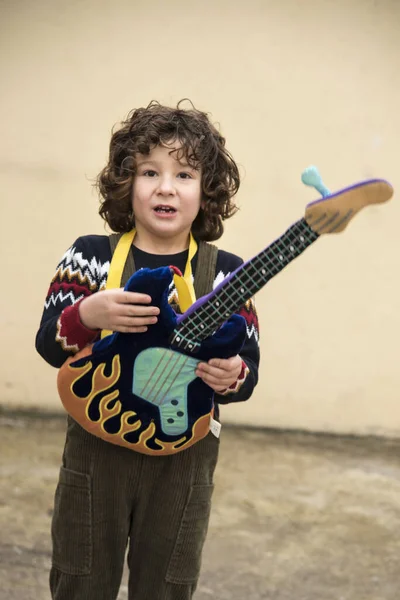 Boy Playing Experimenting Toy Guitar Striking Colors — 스톡 사진