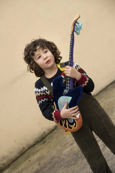 Boy Playing Experimenting Toy Guitar Striking Colors — 스톡 사진