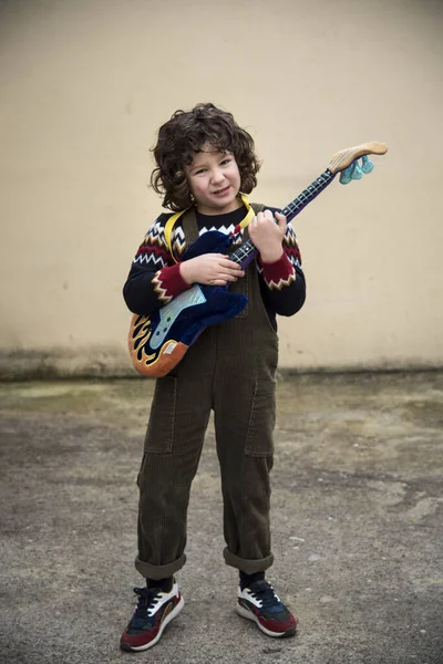 Boy Playing Experimenting Toy Guitar Striking Colors — 스톡 사진