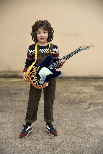 Boy Playing Experimenting Toy Guitar Striking Colors — 스톡 사진