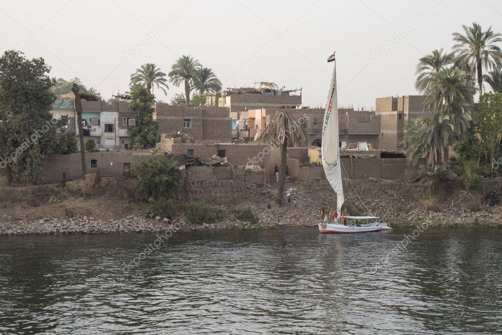 The Nile River in the vicinity of Luxor, Egypt, Africa with its crops, its boats, its towns and its cruise ships. Beautiful view.