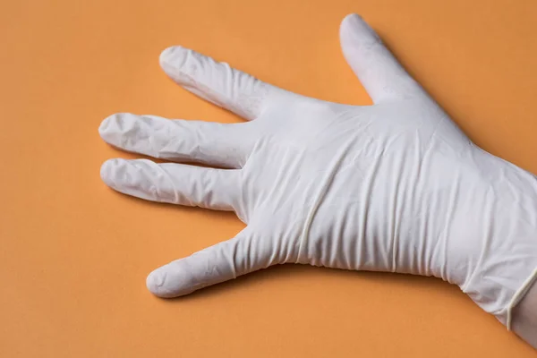 Light Colored Sanitary Glove Placed One Hand Orange Background — Stock Photo, Image