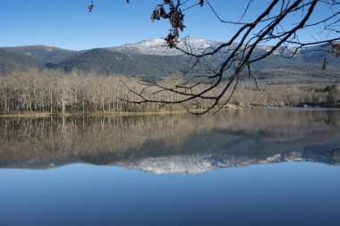 Segovia 'daki Ponton Reservoir; İspanya' daki Castilla y Leon; Avrupa. Su deposunu çevreleyen arazinin sularında güzel bir yansıma..