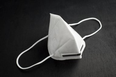 Siyah arka planda beyaz yüz maskesi. Bulaşıcı hastalığı önlemek için koruyucu..