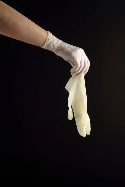 Hand Latex Glove Holding Equal Glove Black Background Protection Contagions — Stock Photo, Image