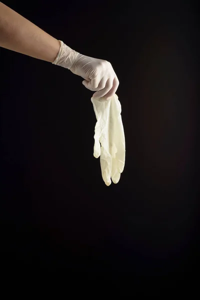 Hand Latex Glove Holding Equal Glove Black Background Protection Contagions — Stock Photo, Image