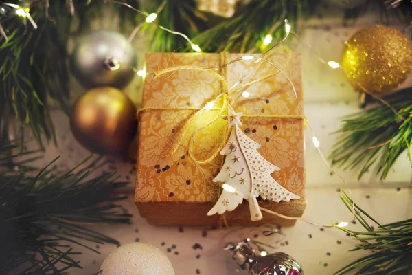 Weihnachtsgeschenk unter dem Weihnachtsbaum mit Bindfäden und Geschenkpapier umwickelt — Stockfoto