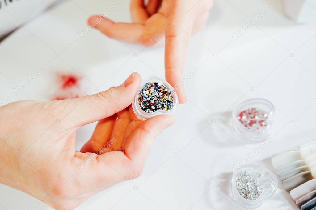 Multicolored rhinestones in a box for makeup and manicure