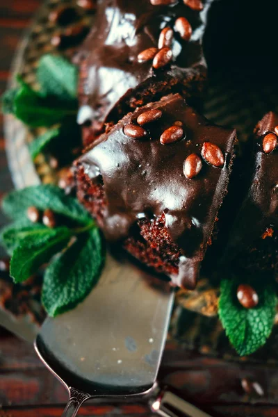 Sweet chocolate cake with cacao icing and decorated with mint