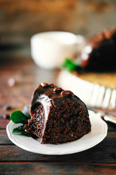 Sweet chocolate cake with cacao icing and decorated with mint