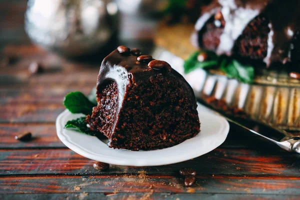 Sweet chocolate cake with cacao icing and decorated with mint