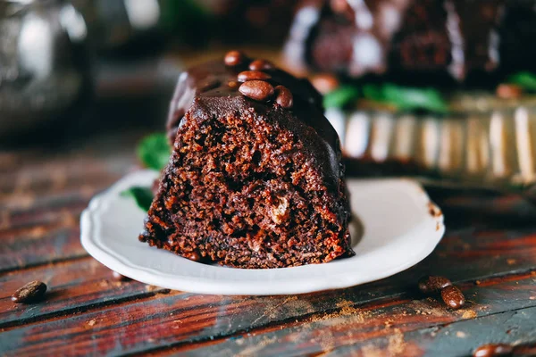 Sweet chocolate cake with cacao icing and decorated with mint