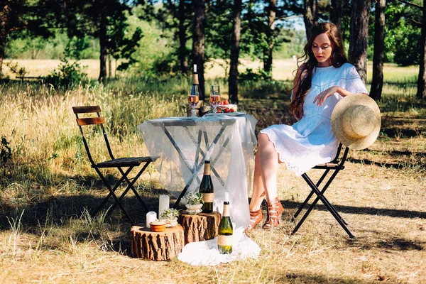 夏の婚約ピクニック 若い花嫁は夕食のためにテーブルに座って — ストック写真