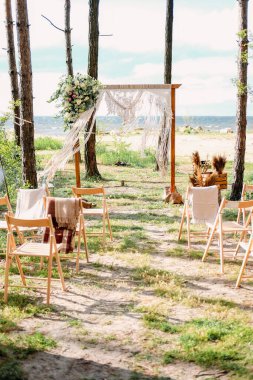 Kumsalda düğün. Misafirler ve çam ormanlarında yeni evliler için kemer..