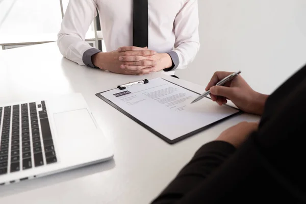 Interview employee reading a resume with the job seeker sitting in front, Job applications concepts.