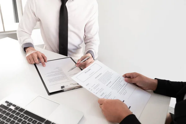 Interview employee reading a resume with the job seeker sitting in front, Job applications concepts.