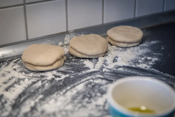 raw homemade chinese pancakes on grey table with flour