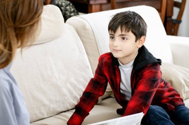 Nişanlı çocuk, kendisine evde bir hikaye anlatan anneyi dinler.