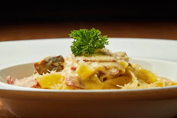 Carbonara pasta, pasta, meat, Italian dish, presentation and serving, menu, beautifully decorated dish, delicious food, tasty and hot pasta, greens, plate