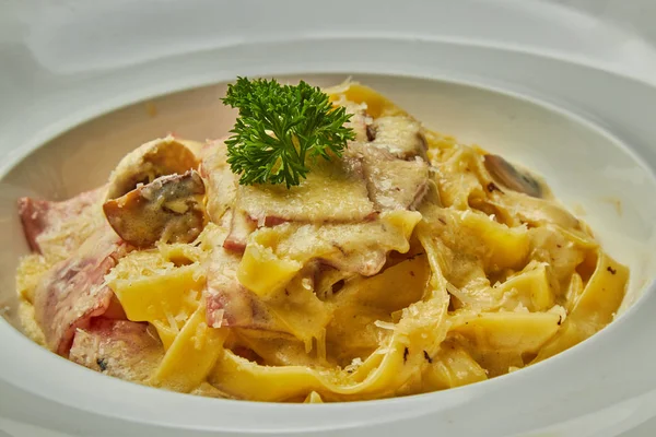 Carbonara pasta, pasta, meat, Italian dish, presentation and serving, menu, beautifully decorated dish, delicious food, tasty and hot pasta, greens, plate