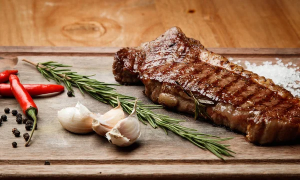 steak from beef, steak with vegetables, proper nutrition, healthy food, a piece of boiled pork on a wooden board, presentation and serving, rustic style, vegetables for meat, healthy food