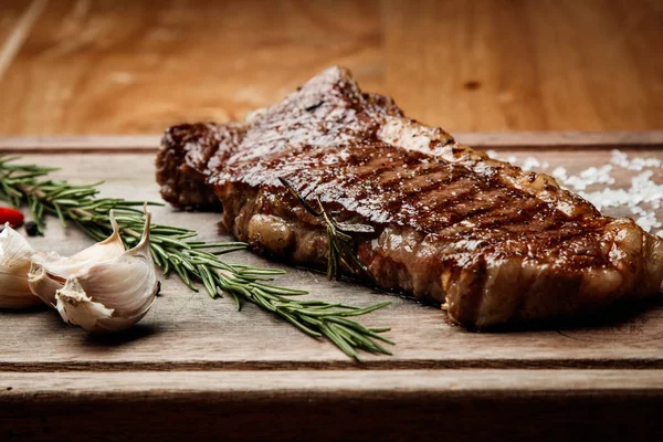 steak from beef, steak with vegetables, proper nutrition, healthy food, a piece of boiled pork on a wooden board, presentation and serving, rustic style, vegetables for meat, healthy food