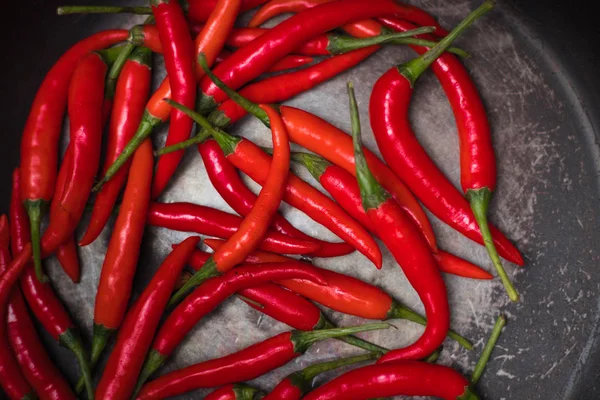 hot peppers, red peppers.A large amount of hot red chili pepper. Spicy, burning vegetables. Delicious food, pepper, vegetable, restaurant, dish