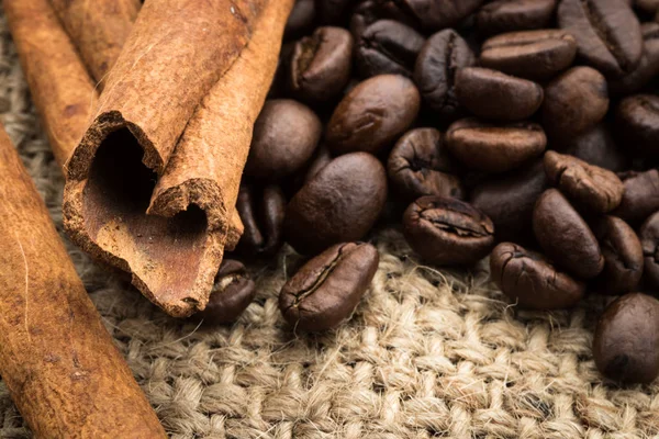 coffee with cinnamon, background, country style, cinnamon sticks. Freshly roasted coffee beans breakfast drink.