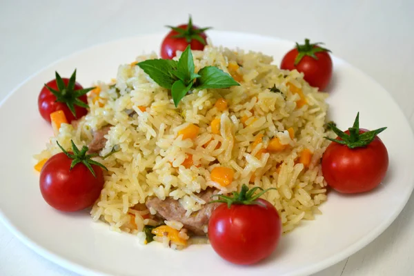 rice porridge with vegetables on a white plate