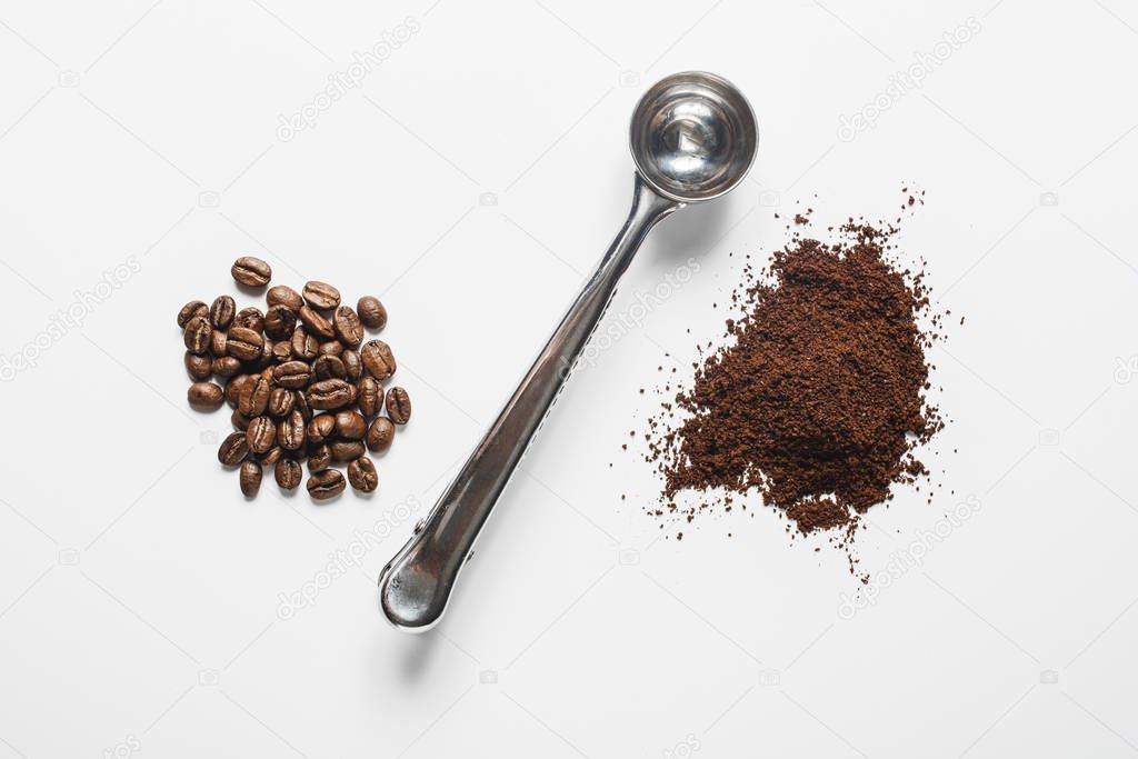 whole bean and ground coffee on a white background divided by a measuring scoop.