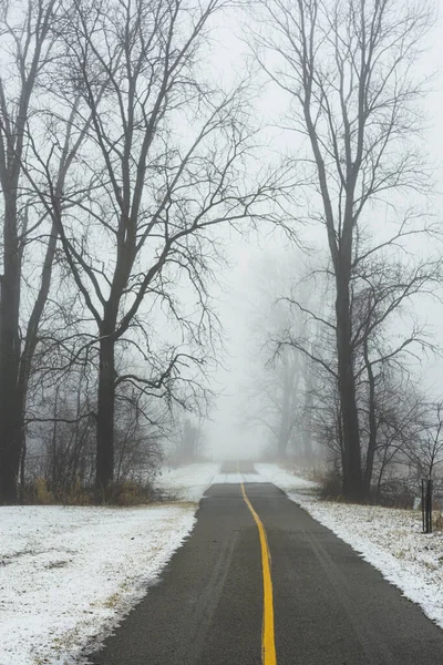 stock image Mysterious Winter trail disappearing into the fog.