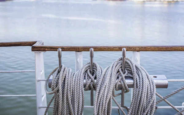 Closeup of coiled rope on a ship deck in summer