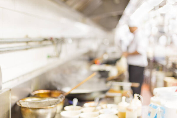 Motion blur chefs of a restaurant kitchen