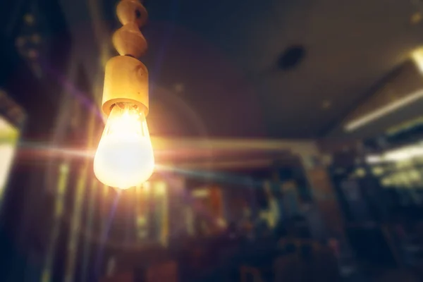 Lamp bulb with light flare in the restaurant room
