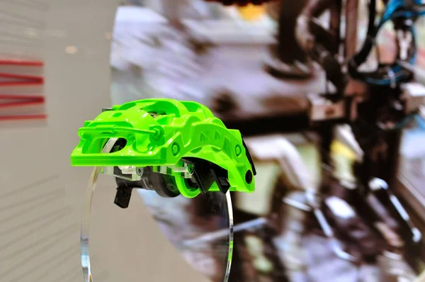 Green car disc brake caliper presented on acrylic glass. — Stock Photo, Image