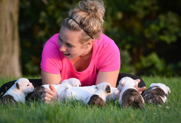 Woman playing with puppies — Stock Photo, Image