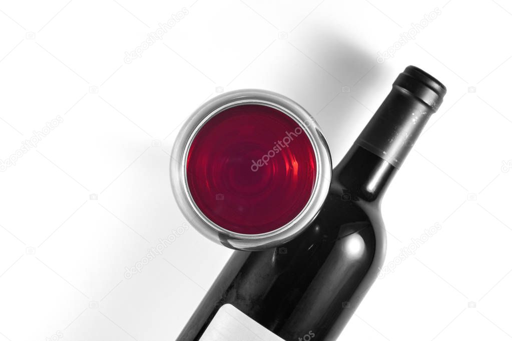 Black and white image of a bottle and glass with red wine