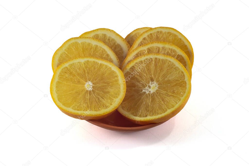 Sliced orange slices in an orange plate on a white background