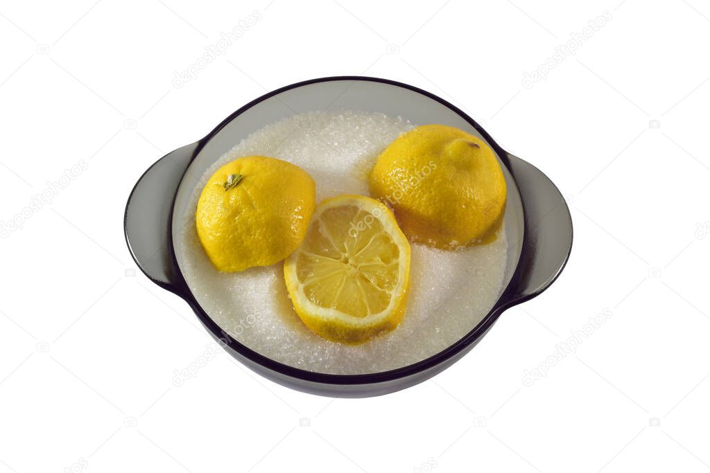 Slices of lemon in granulated sugar in a transparent dark plate on a white background