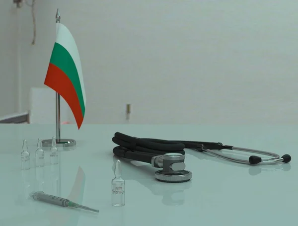 Bulgaristan 'daki bir sağlık masasında şırınga, COVID 19 koronovirüs aşısı ve fonendoskop.