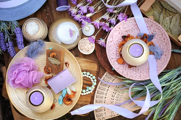 Flat lay spa accessories, handmade artisan soap, fresh flowers, wisp of bast, candles, bath salt — Stock Photo, Image
