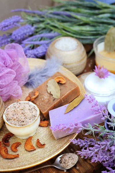 Natural cosmetics concept background - coffee and lavender artisan soap, salt scrub, cream and flowers