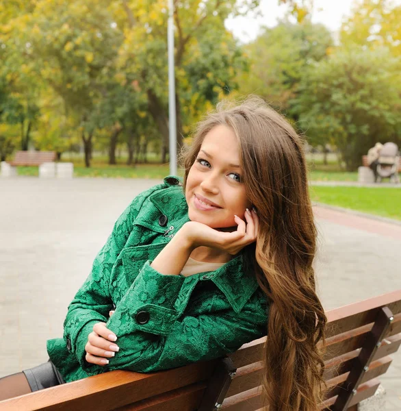 Beautiful yound woman portrait dressed in emerald green coat — Stock Photo, Image