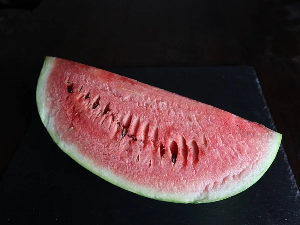 Red  watermelon slice on black — Stock Photo, Image