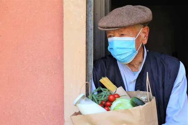 smart food delivery service,  fresh food to recipient senior older alone man customer receiving order from courier at home, express delivery, food delivery, online shopping concept. Food box donation. Social help